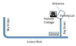 A map showing the entrance , parking lot , library , and historic cottage.