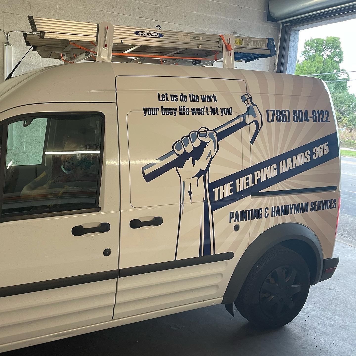 A white van with the helping hands logo on it