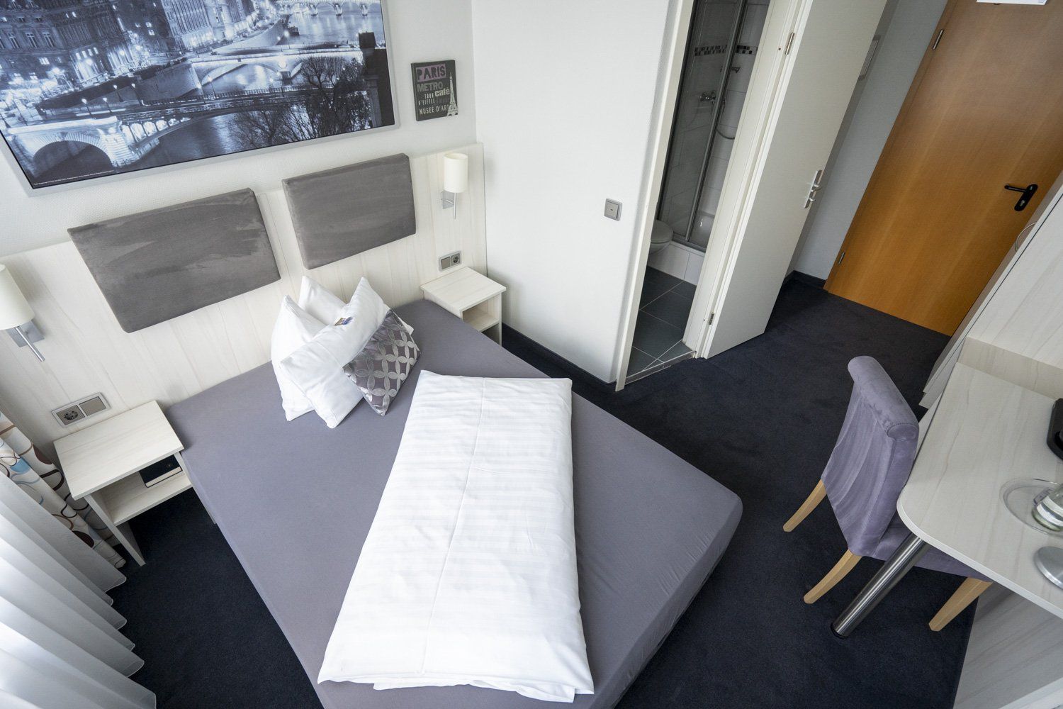 Eine Luftaufnahme eines Hotelzimmers mit einem Bett und einem Schreibtisch