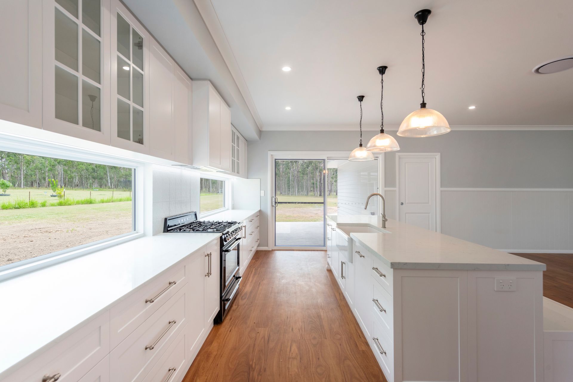 A Kitchen With White Cabinets And Stainless Steel Appliances — Content Stone In Trenayr, NSW