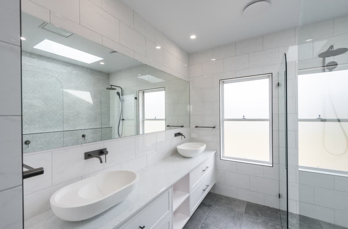 A Bathroom With Two Sinks And A Walk In Shower — Content Stone In Coffs Harbour, NSW