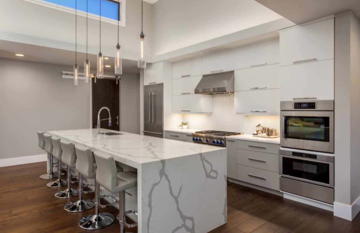 A Kitchen With White Cabinets And A Large Island — Content Stone In Lismore, NSW