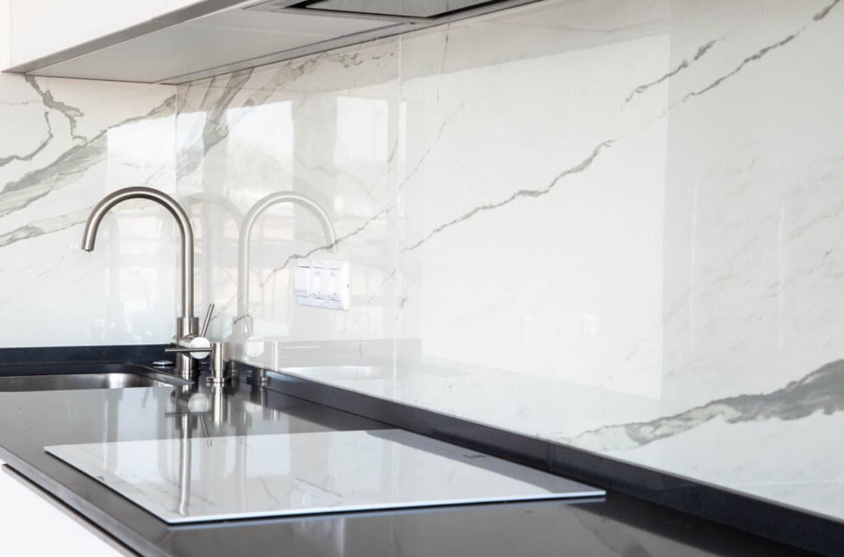 A Kitchen With A Sink , Stove Top Oven , And Marble Counter Tops — Content Stone In Lismore, NSW
