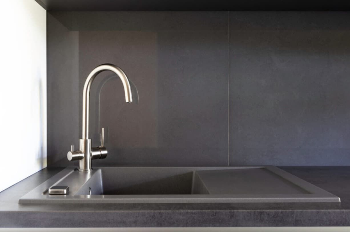 A Kitchen Sink With A Faucet And A Black Counter Top — Content Stone In Glen Innes, NSW