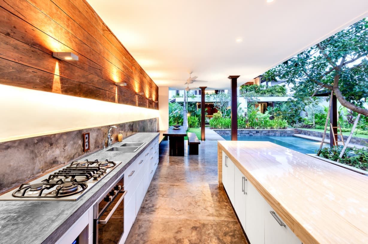 A Kitchen With A Stove Top Oven And White Cabinets — Content Stone In Trenayr, NSW