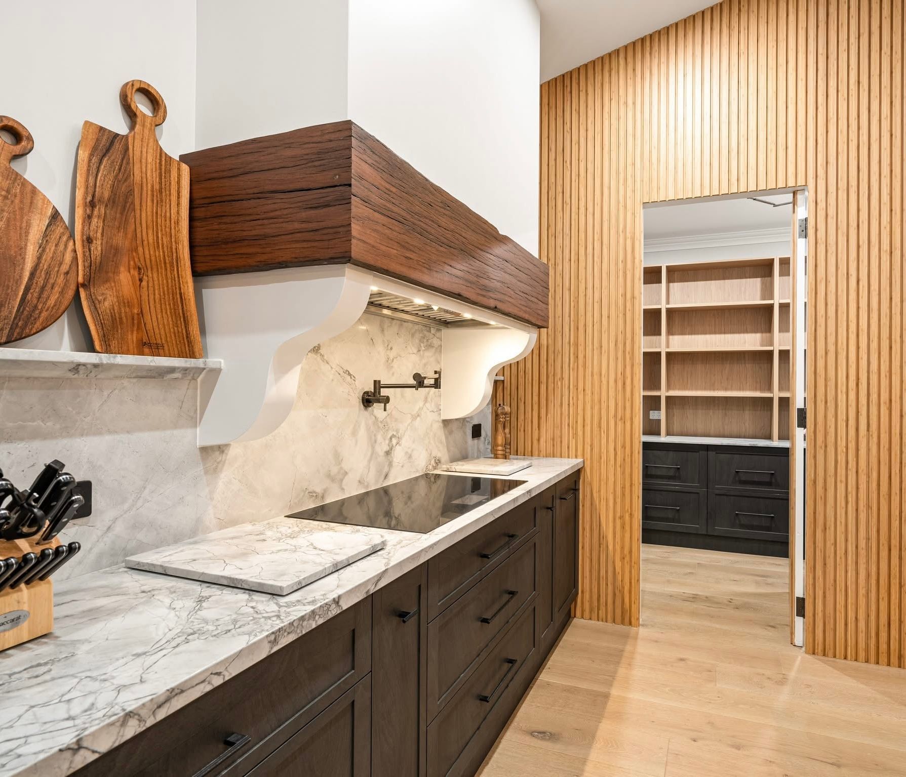 A Kitchen With marble top and dark cupboards — Content Stone In Trenayr, NSW