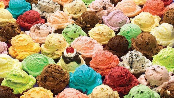 Scoops of various colorful ice cream flavors arranged closely together.