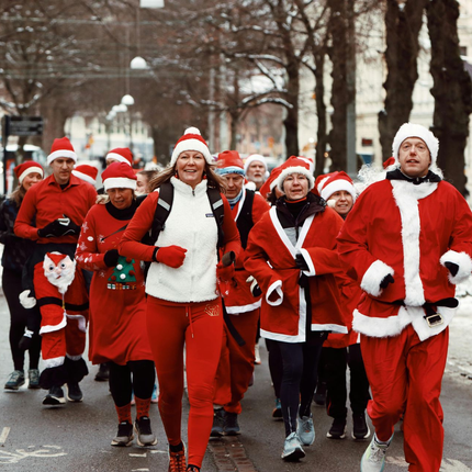 A group of people are running down a street.