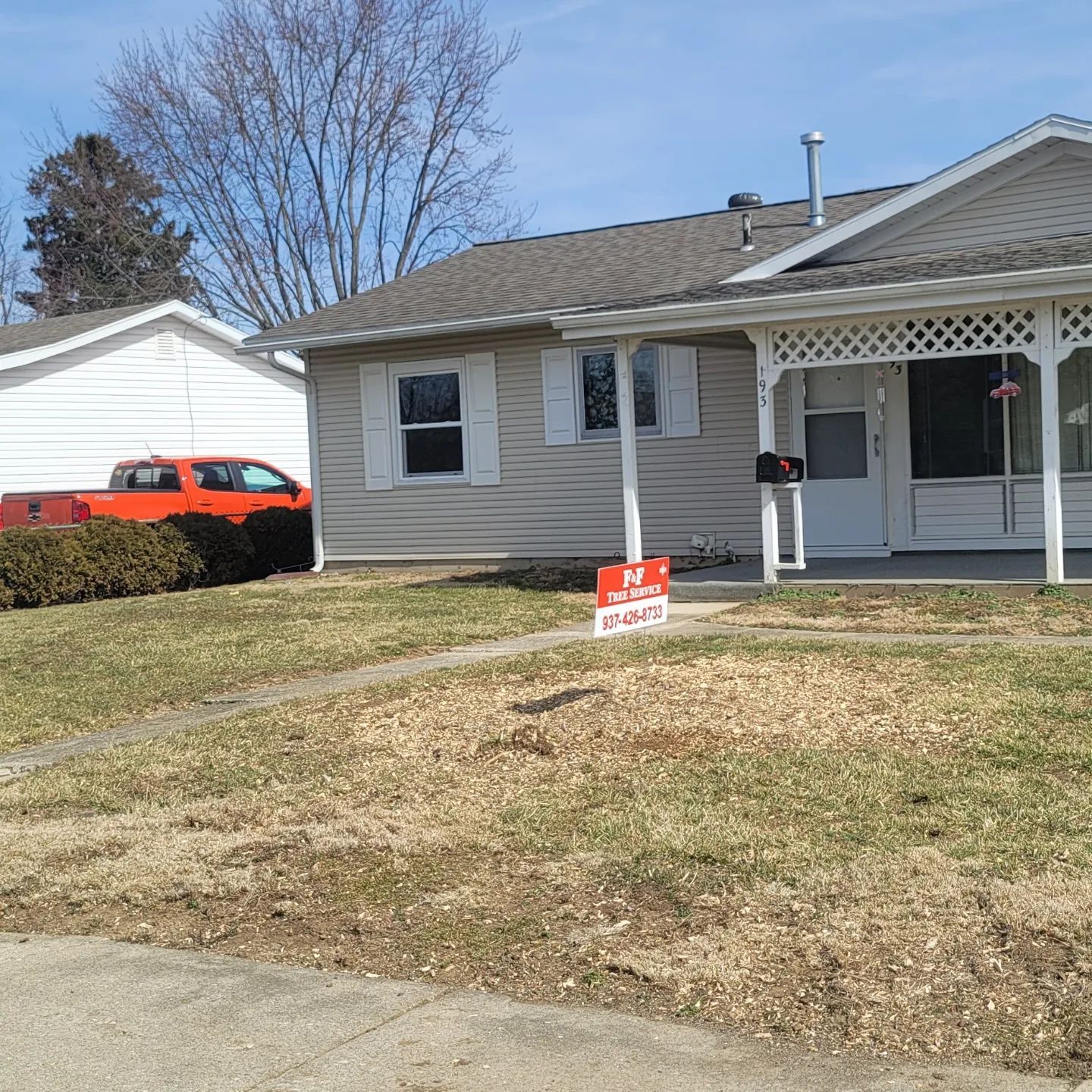 A house with a for sale sign in front of it