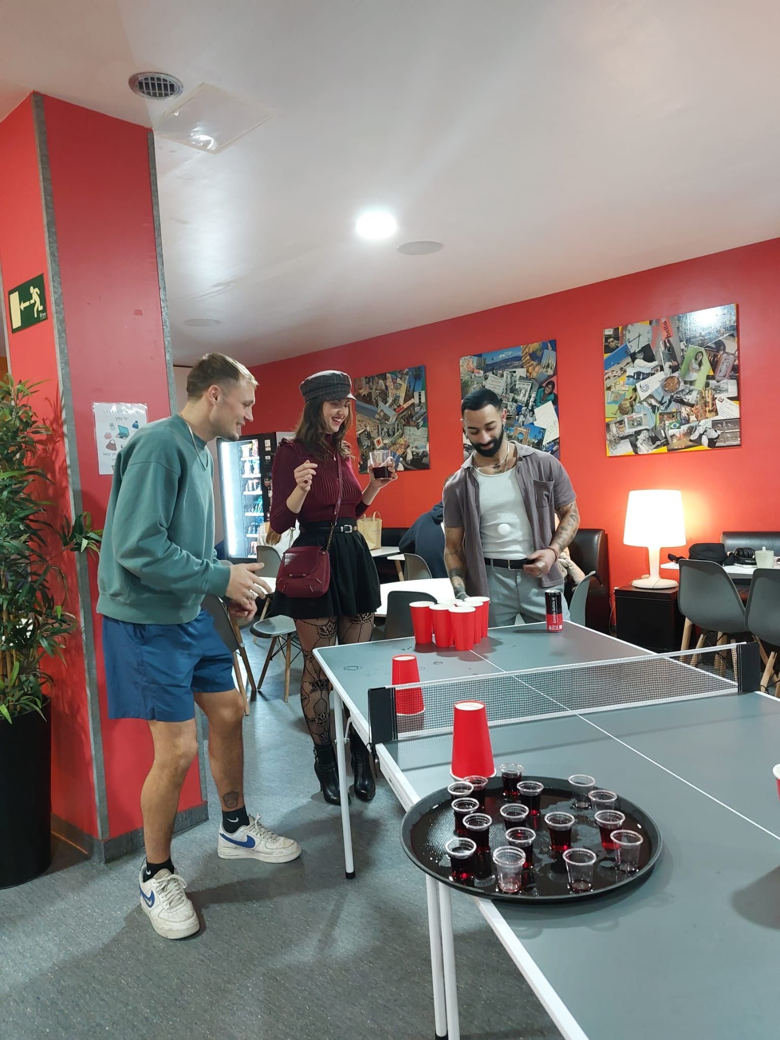 A group of people are playing beer pong on a table.