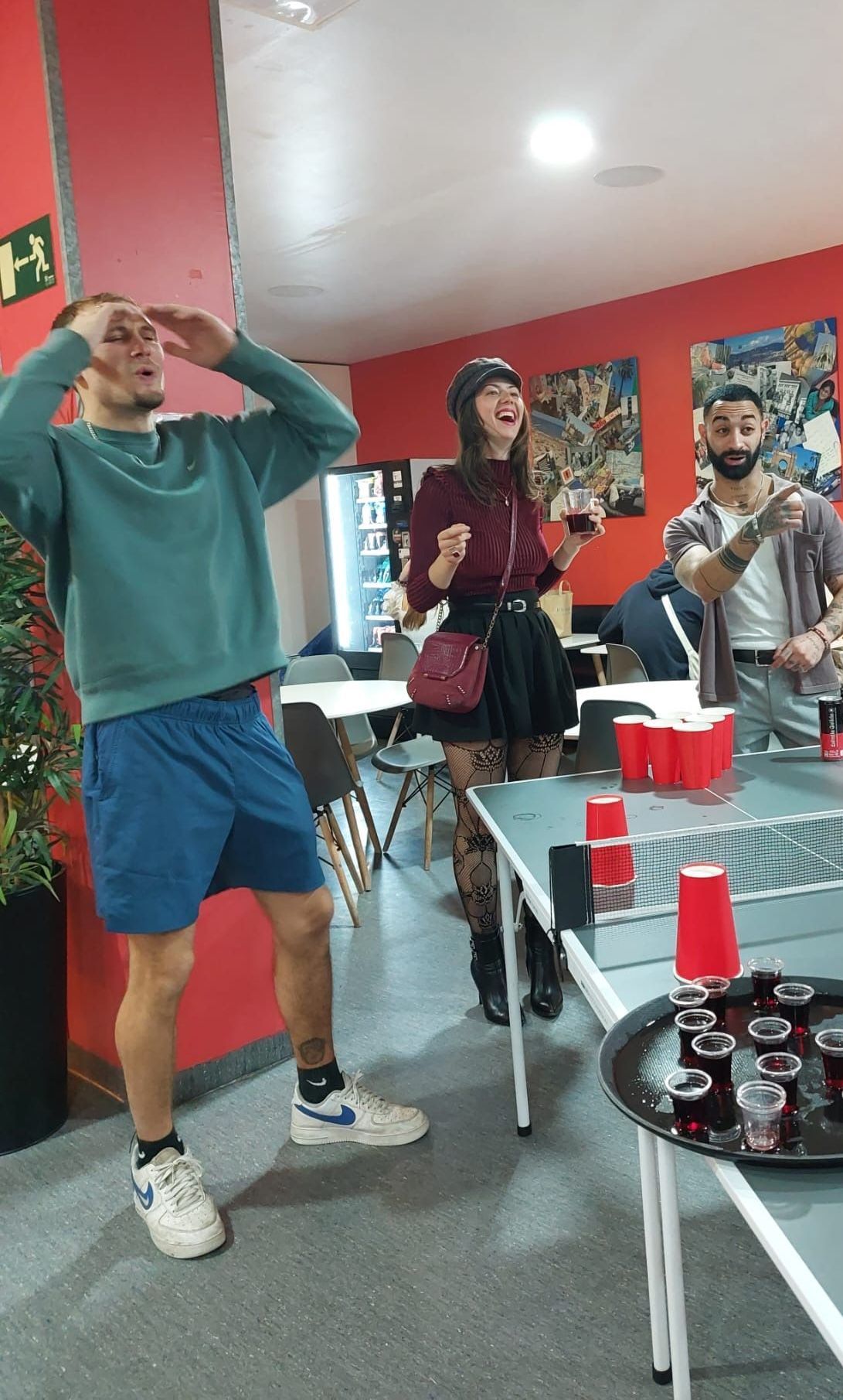 A group of people are playing ping pong in a room.