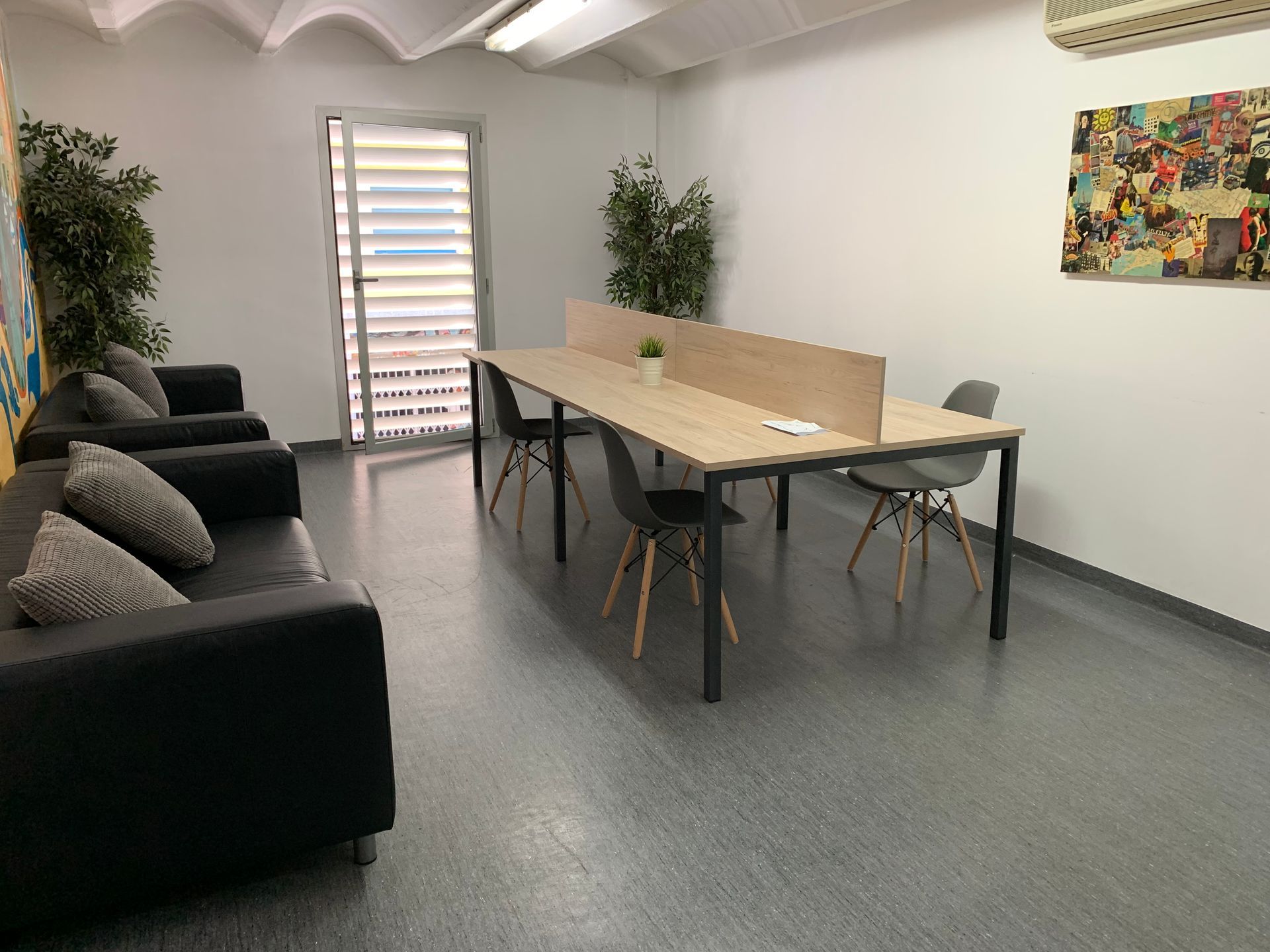 A room with a long table and chairs and a couch