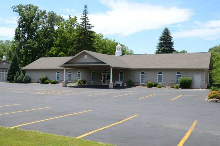 A large building with a parking lot in front of it