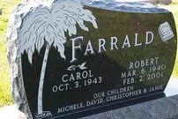 A black gravestone with a palm tree on it.