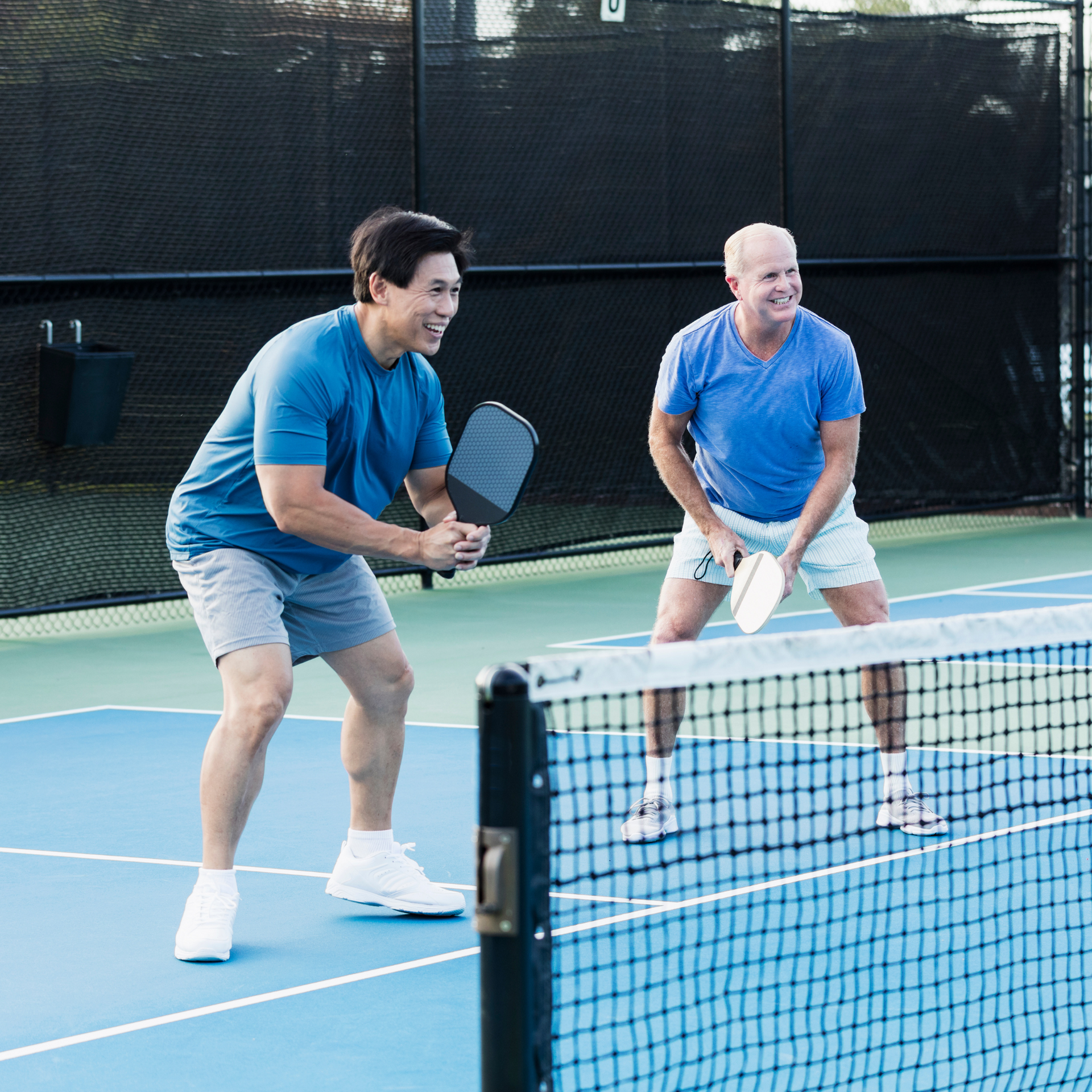 Two men playing pickleball
