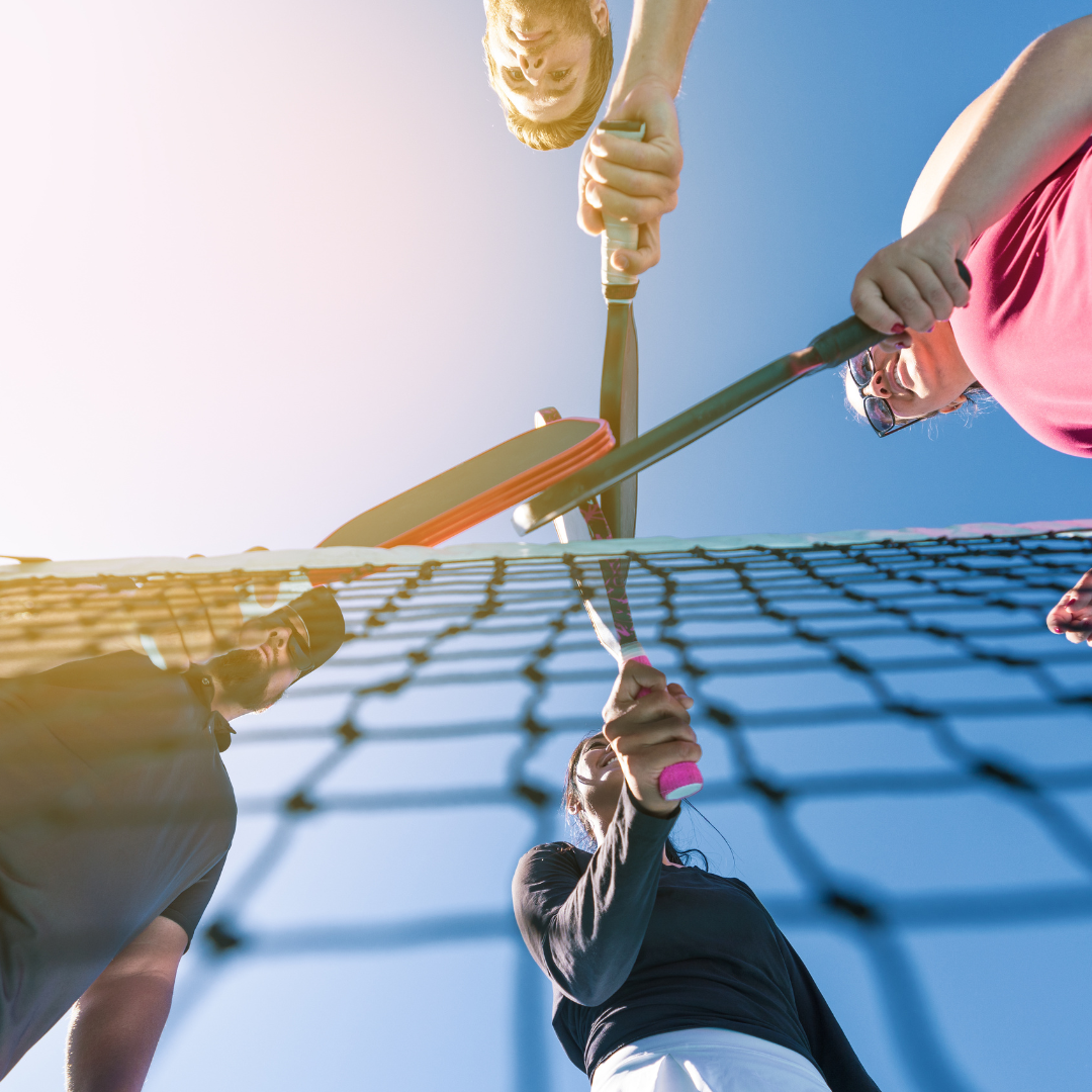 4 Pickleball Paddles at an outdoor pickleball place