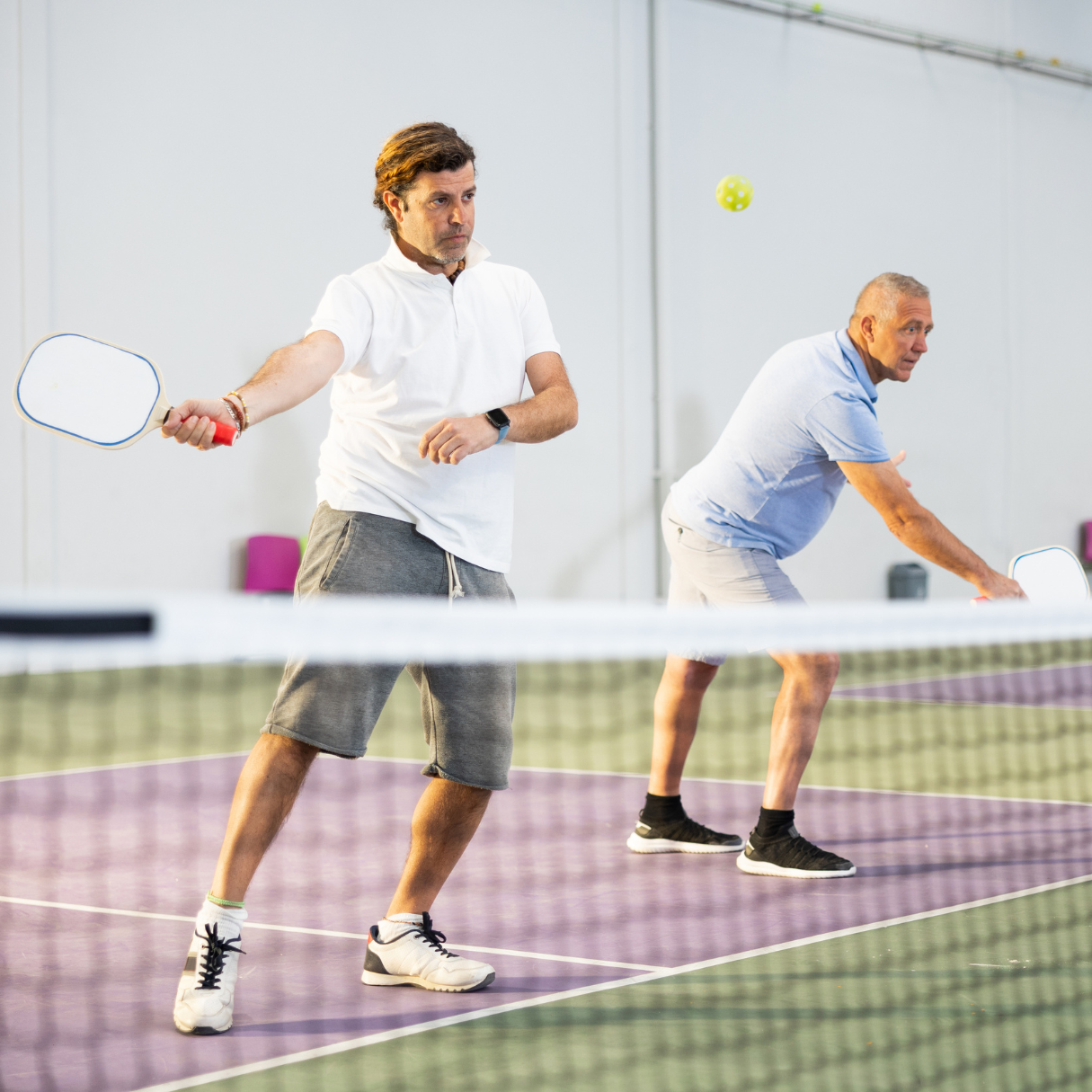 Two men playing pickleball