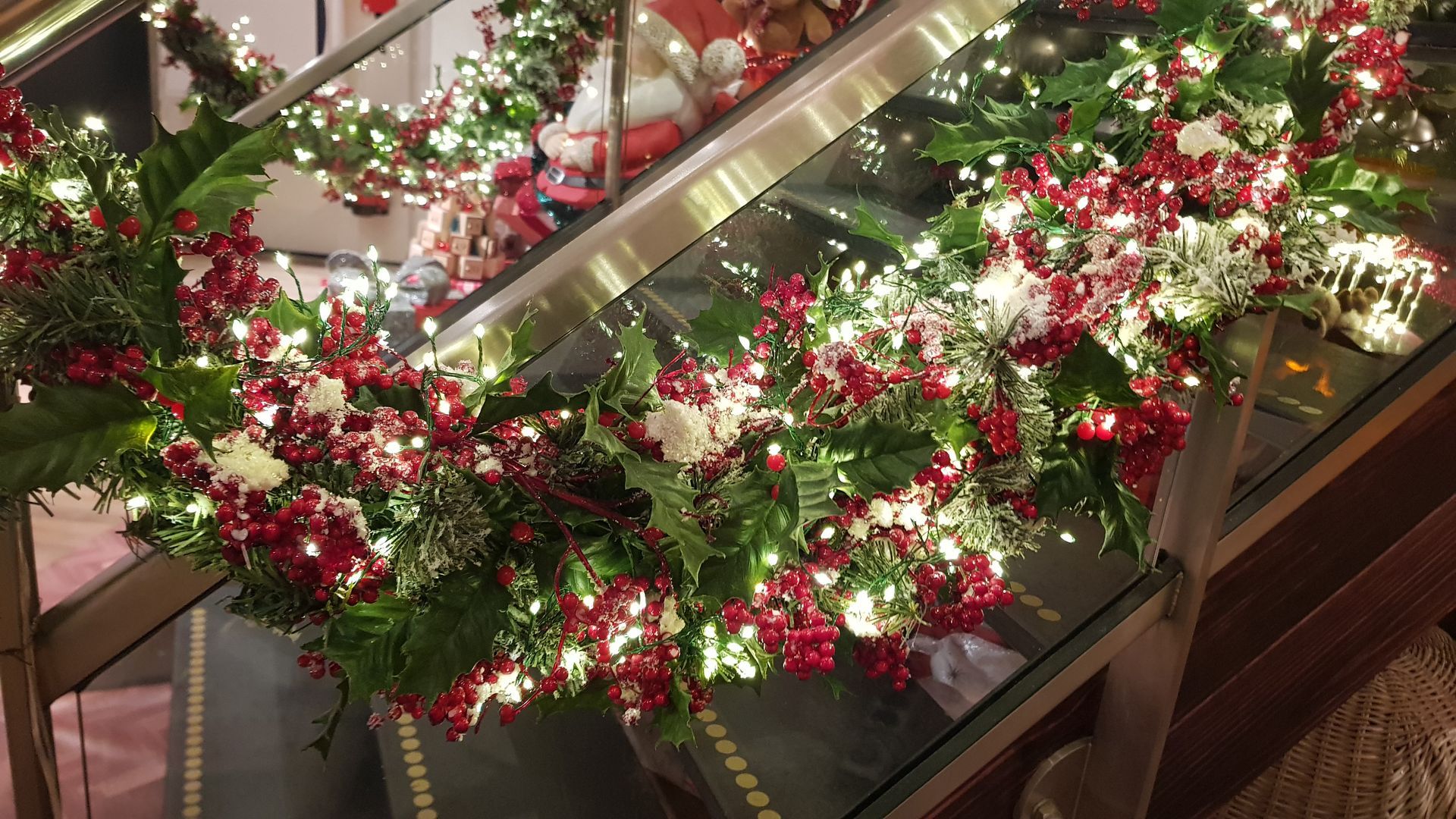 A display case filled with red and white flowers and lights.