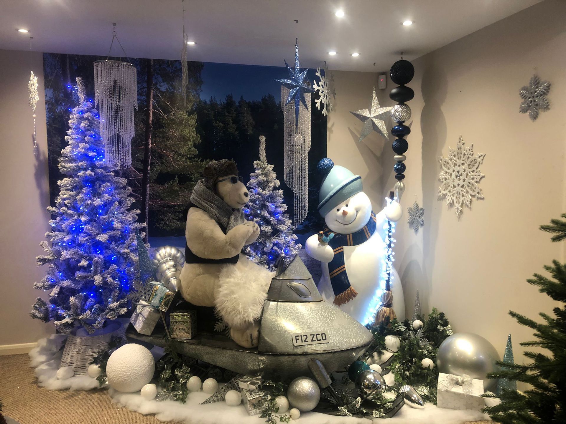 A room decorated for christmas with a polar bear and a snowman.