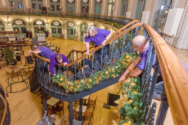 A group of people are cleaning a staircase in a building.