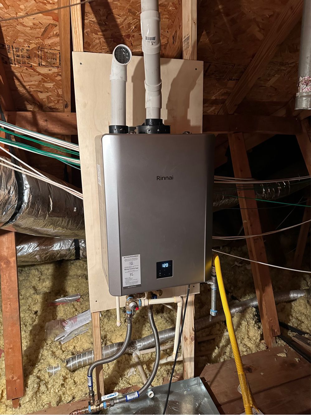 A water heater is installed in the attic of a house.