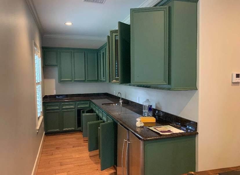 A living room with a fireplace, television, leather armchair, wooden coffee table, and an open dining area beyond.