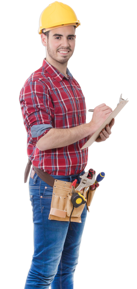 A man wearing a hard hat is writing on a clipboard.