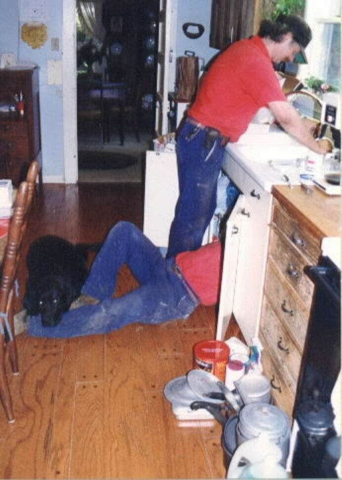 A man in a red shirt is working in a kitchen
