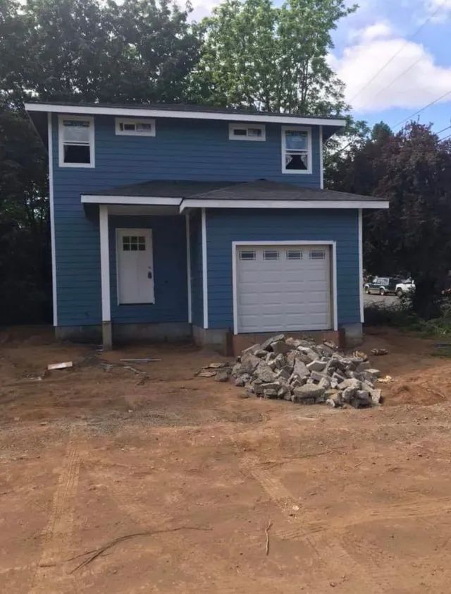 A blue house with a white garage door
