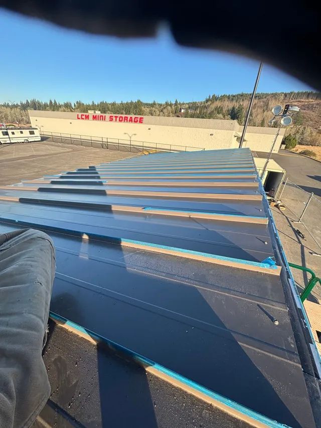 A person is sitting on the roof of a building.
