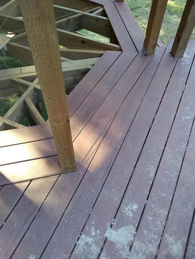 A close up of a wooden deck with a diagonal pattern