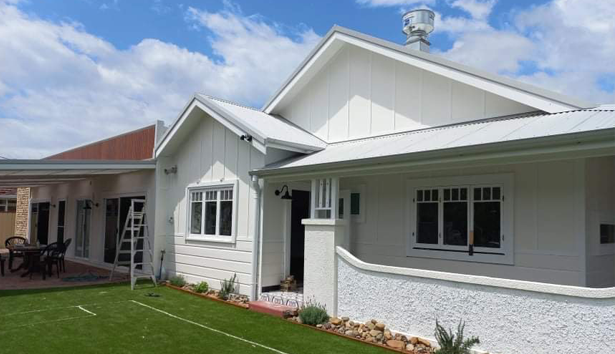 A white house with a blue sky in the background — Heritage Window Awnings in the Hunter Valley, NSW