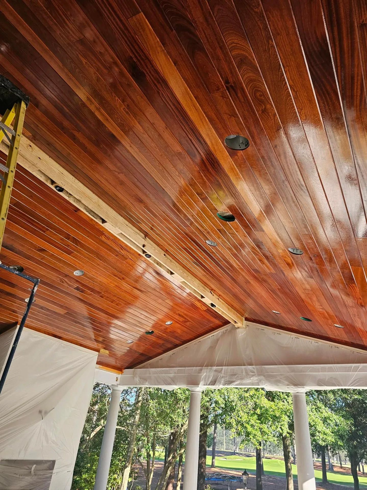 A wooden ceiling with a scaffolding in the background
