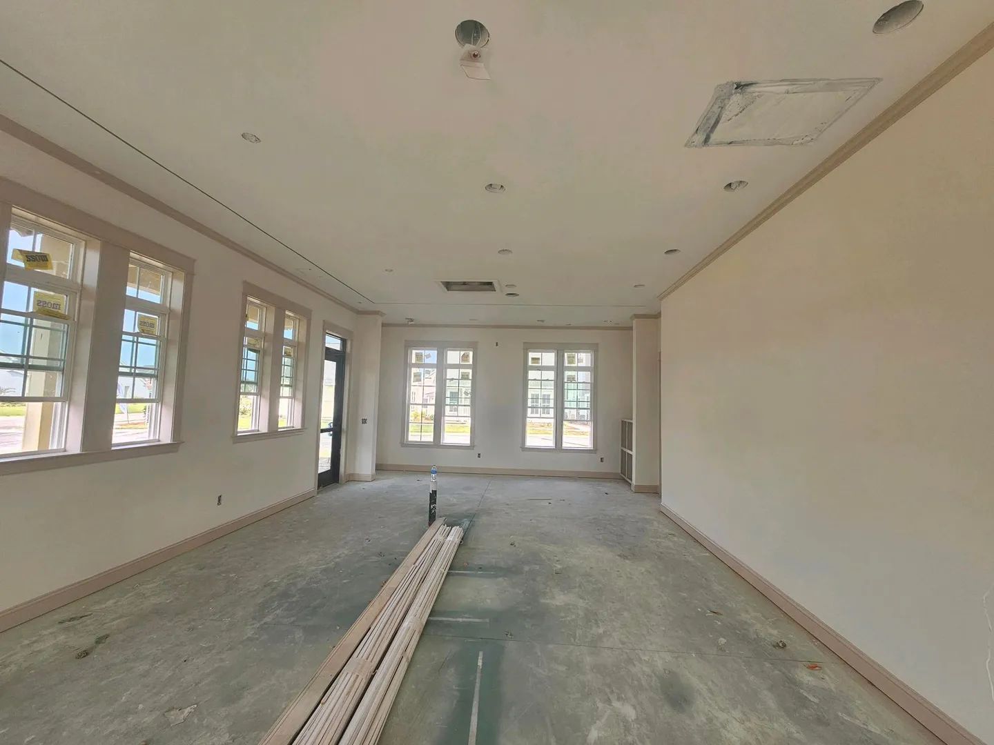 A large empty room with a lot of windows