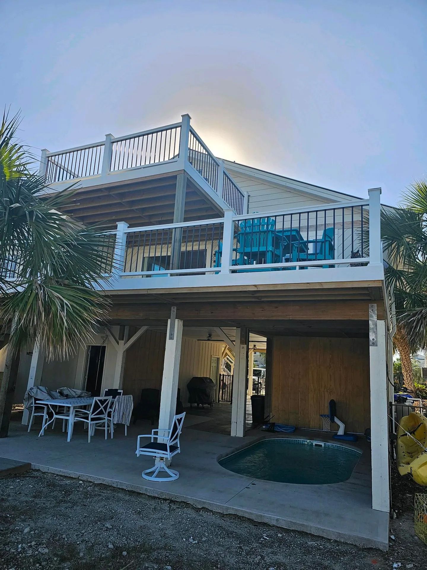 The back of a house with a large deck and a pool.