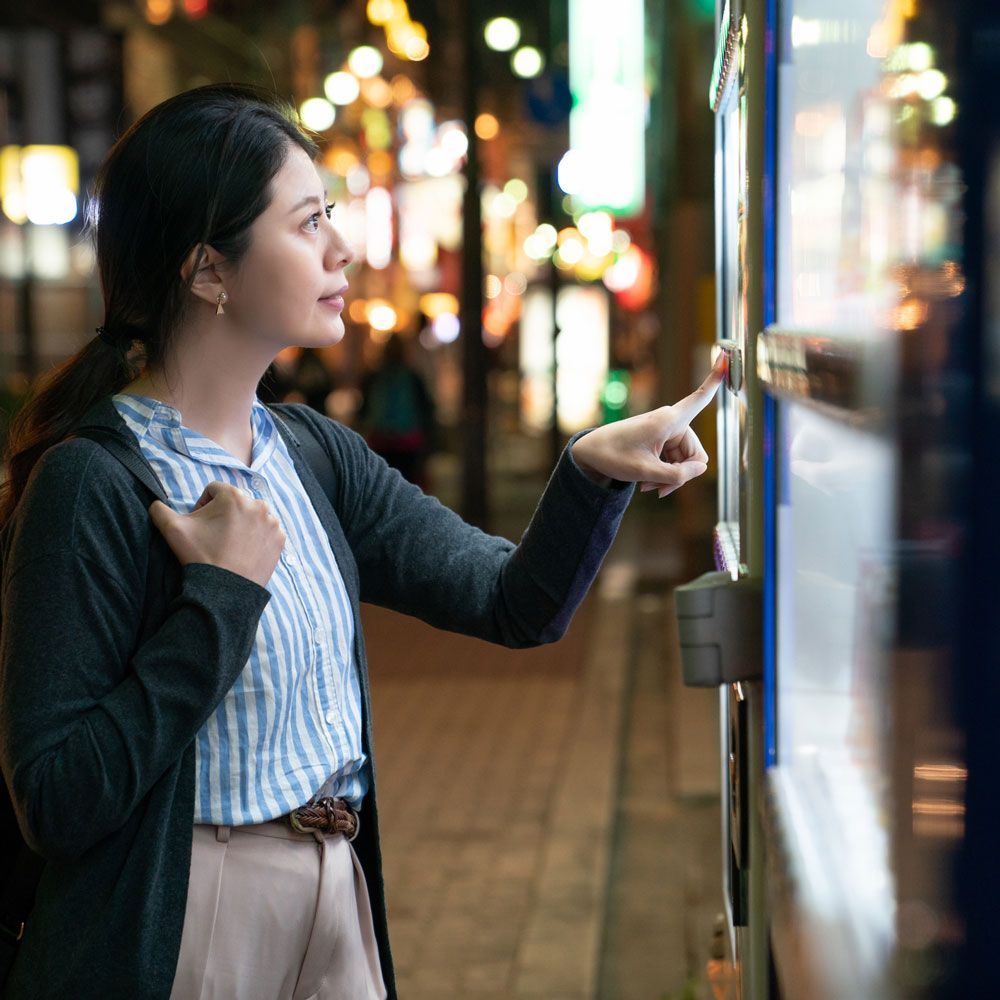 Woman Choosing at A Vending Machine — Orange Park, FL — Northeast Florida Vending Inc