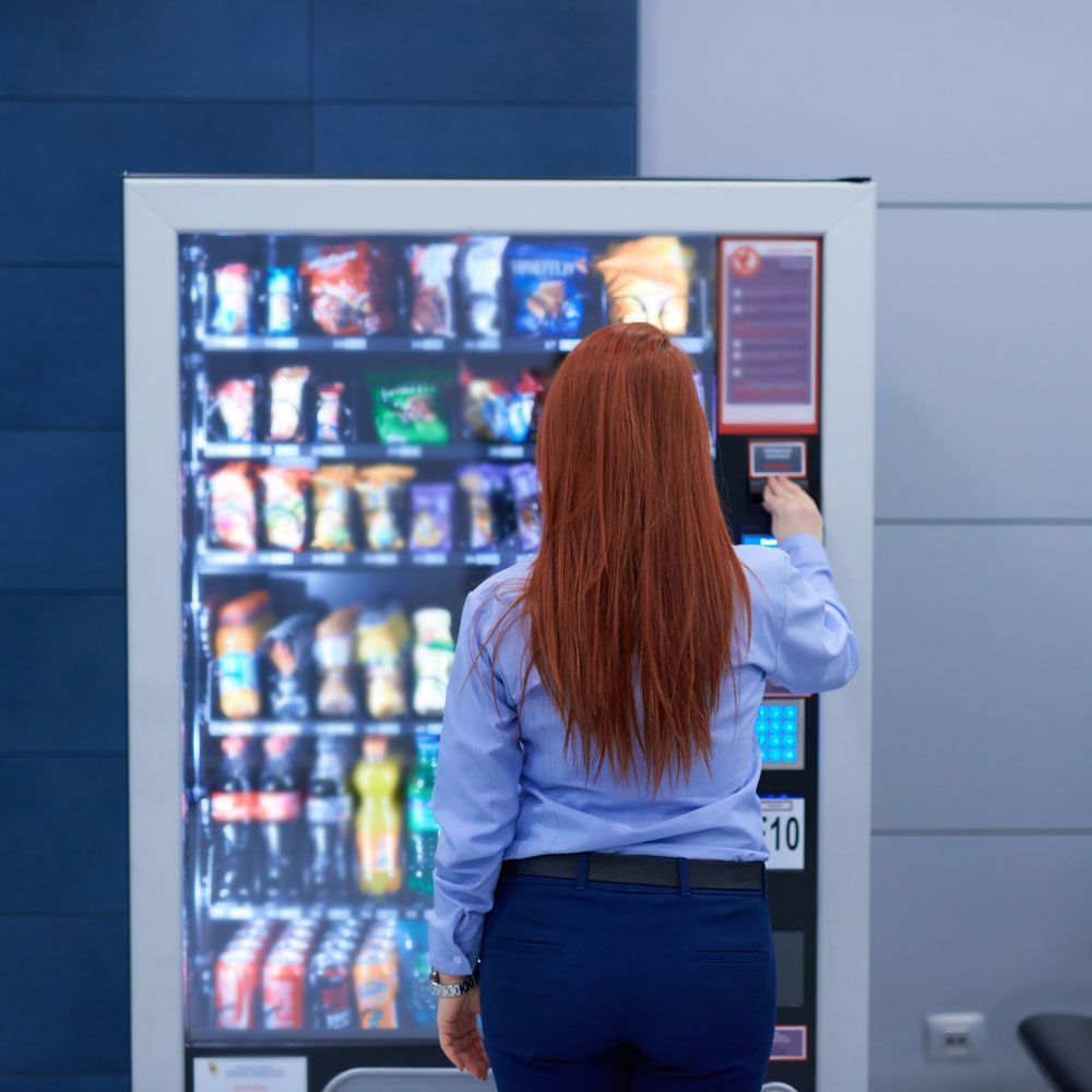 Woman Buying Cold Food — Orange Park, FL — Northeast Florida Vending Inc