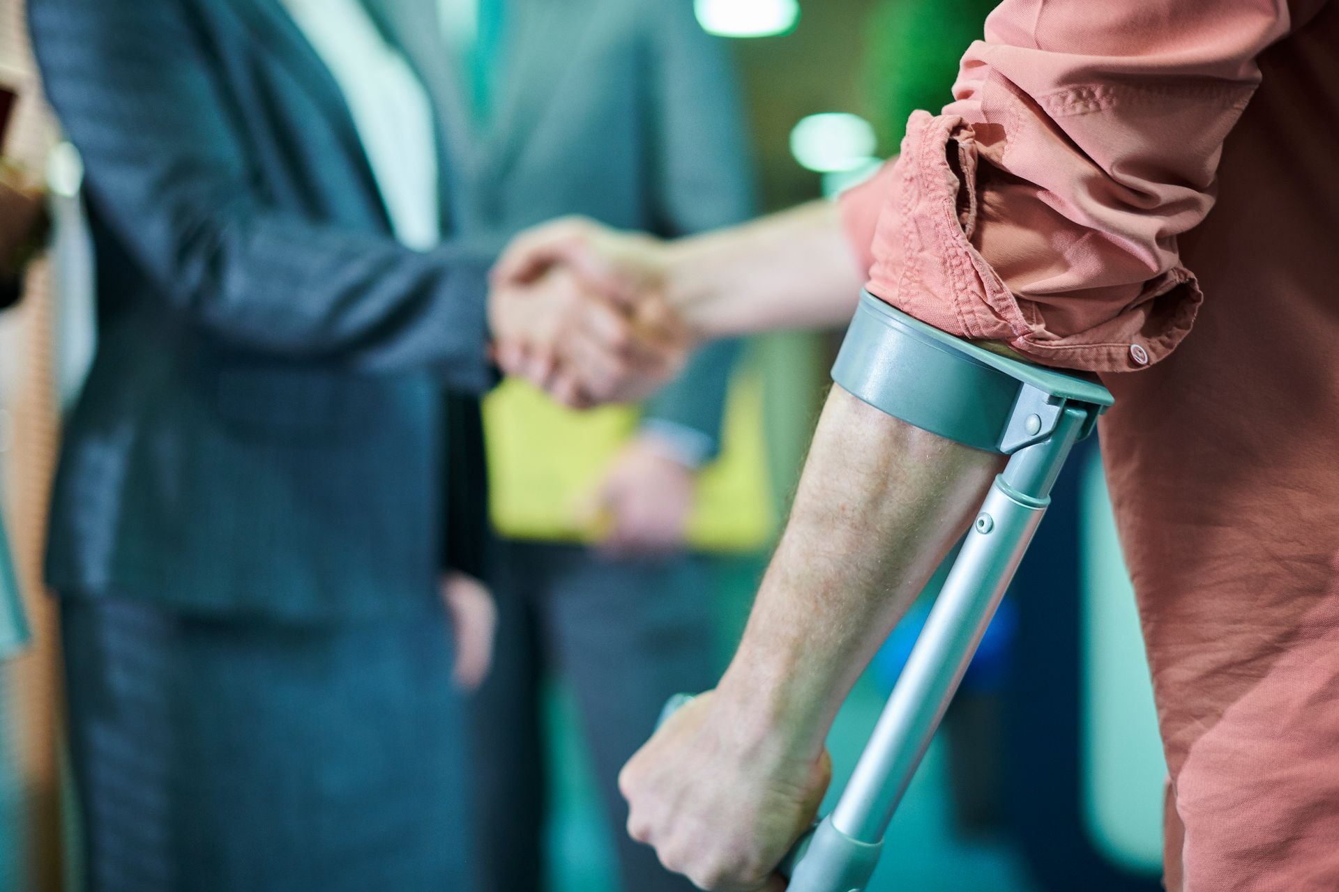 A construction worker is helping another construction worker who is laying on the ground.