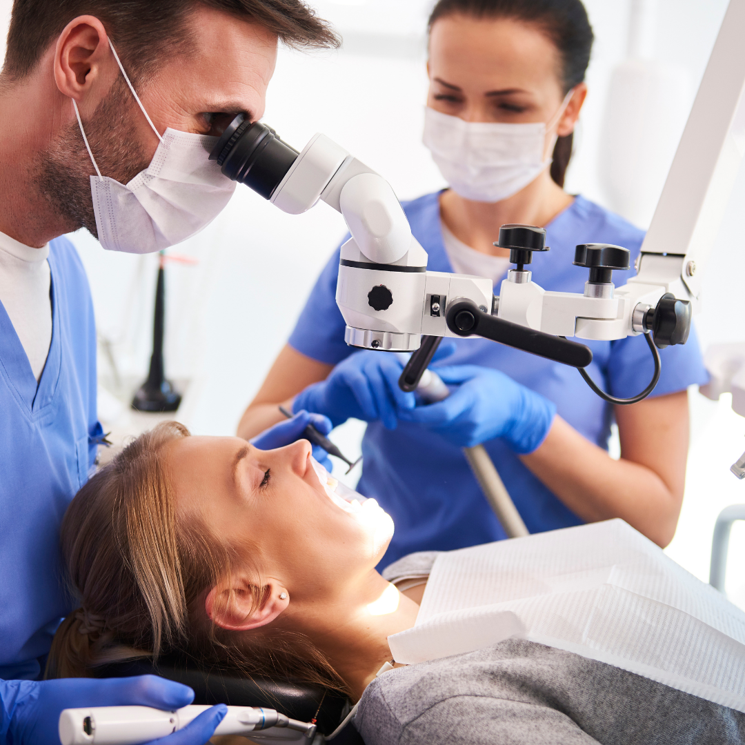 A female dentist providing dental treatment to a patient in a dental office. Experience professional dental care with Upscale Assessment's innovative software for clinical assessment and patient management.