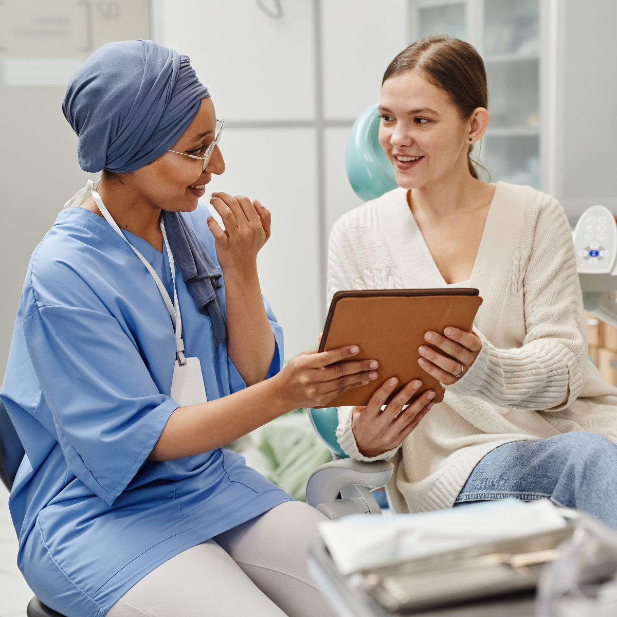 A dental student looking at a patient chart with patient
