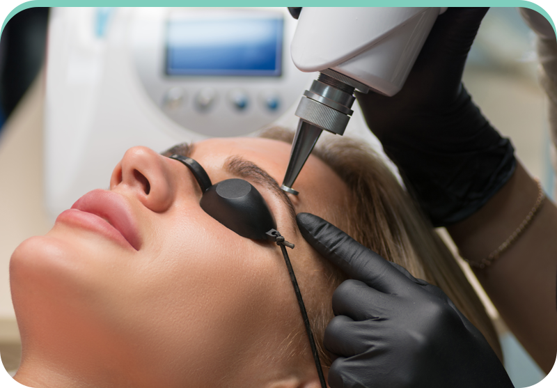 A woman is getting a laser treatment on her eyebrows.