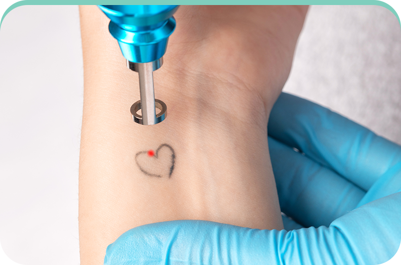 A person is getting a tattoo of a heart on their wrist.