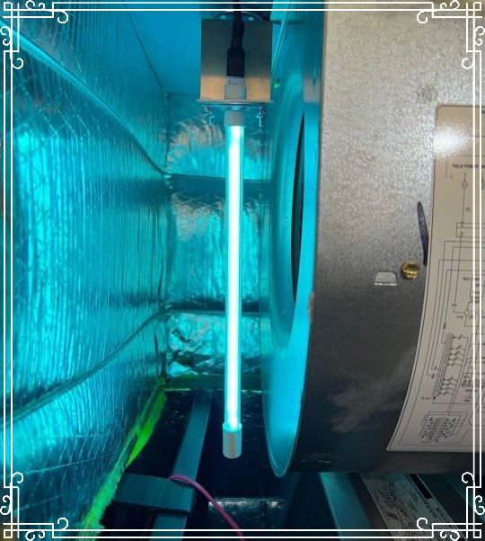 A blue light is shining on a fan in a room