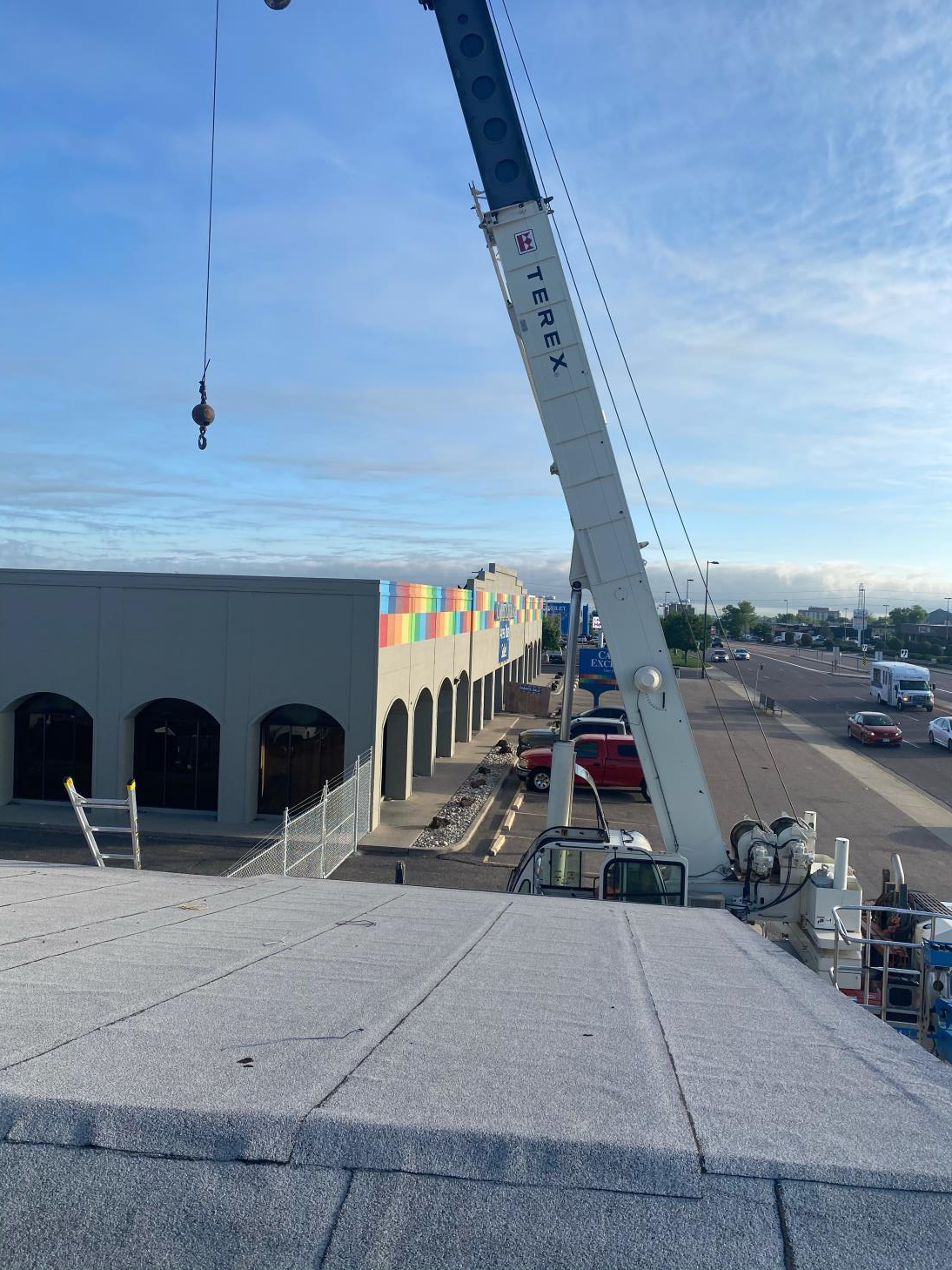 A large crane is sitting on top of a building.