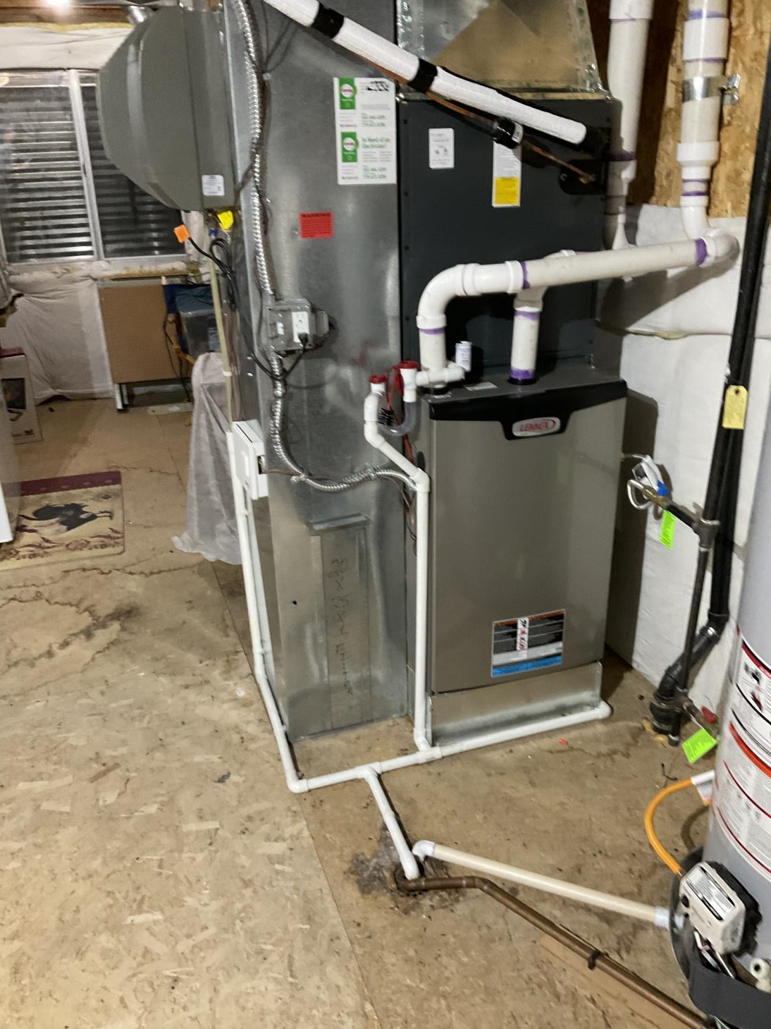 A heating and cooling system is installed in a basement.