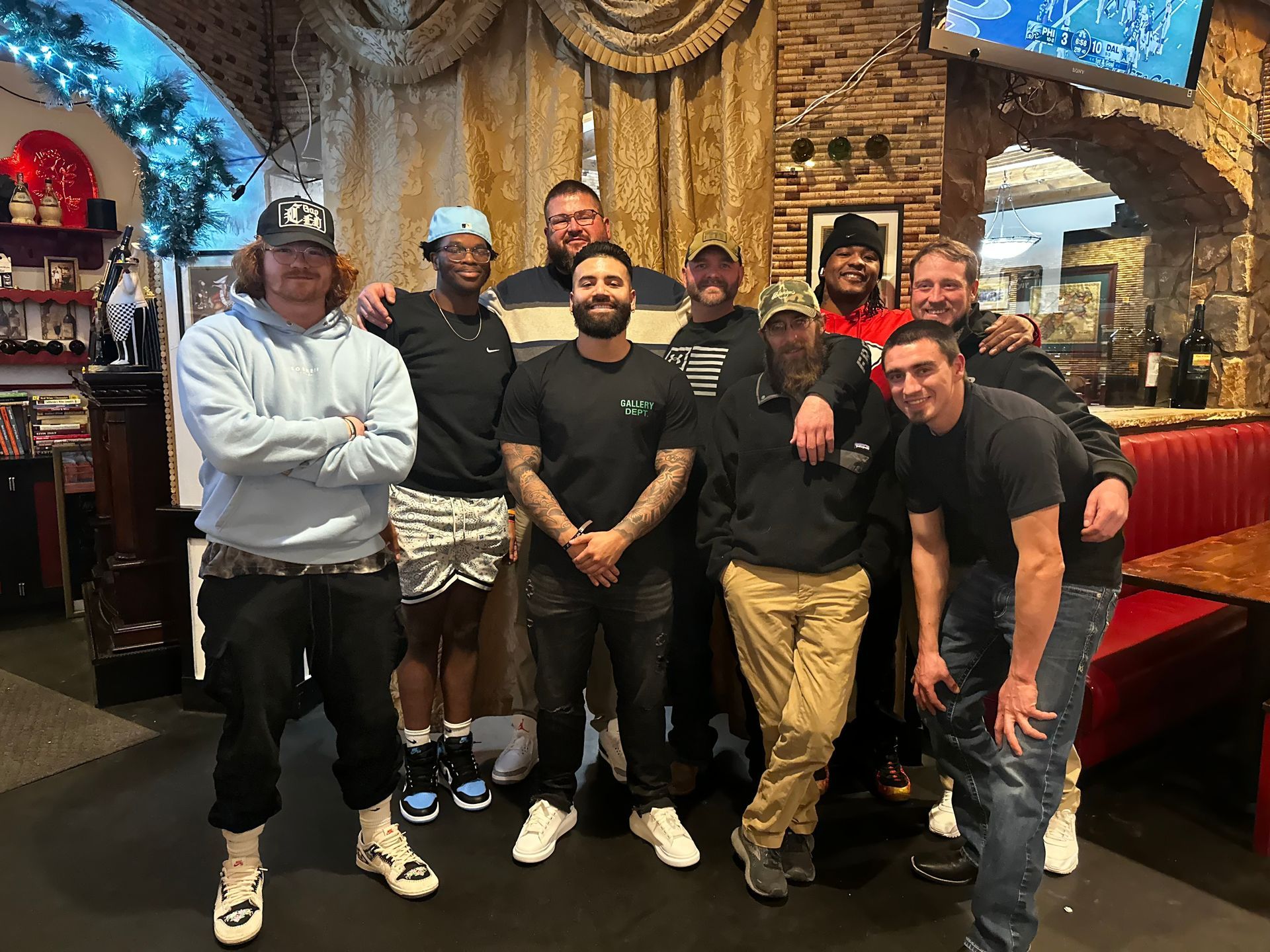 A group of men are posing for a picture in a restaurant.