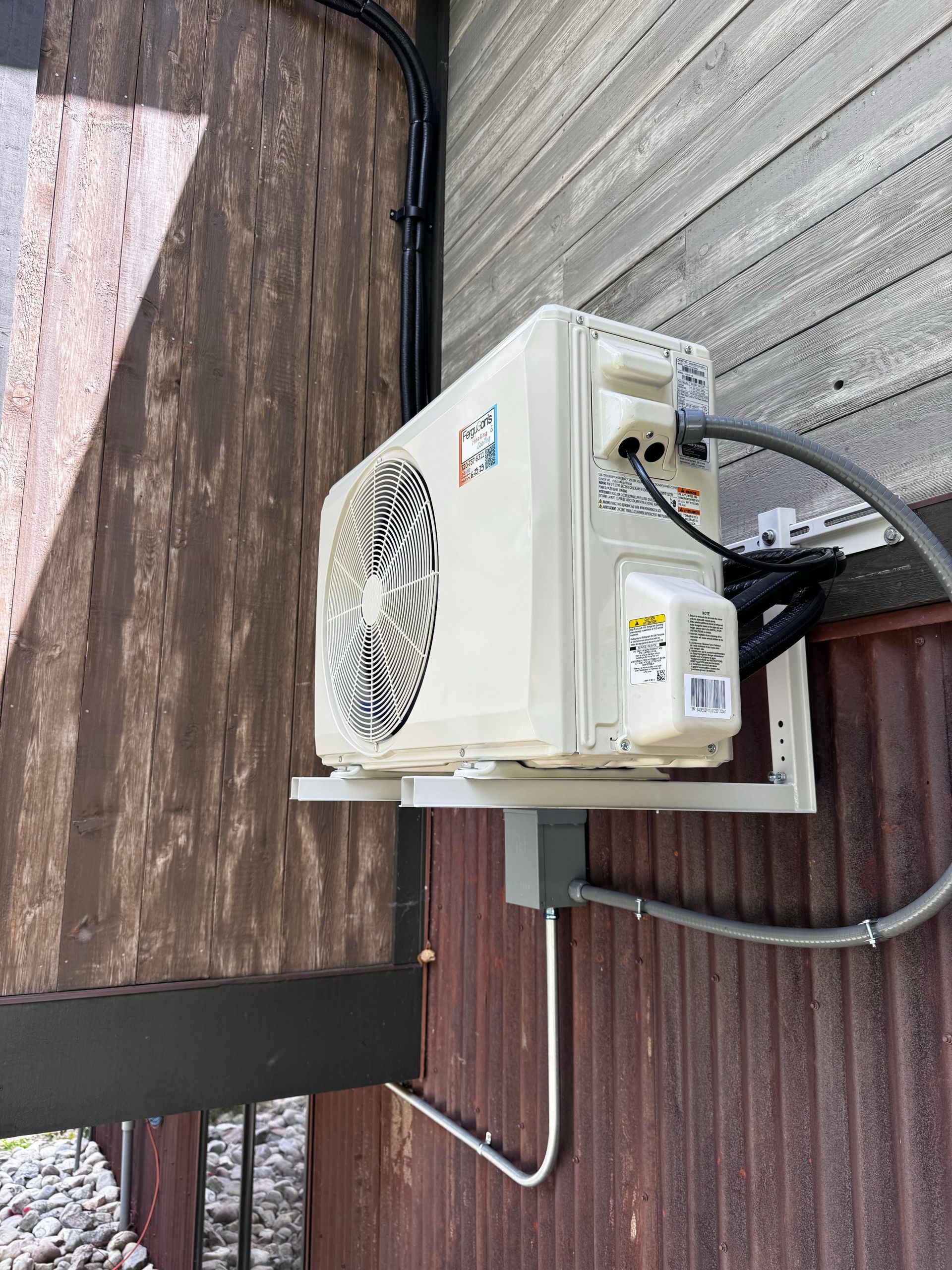 A white air conditioner with a fan attached to it.