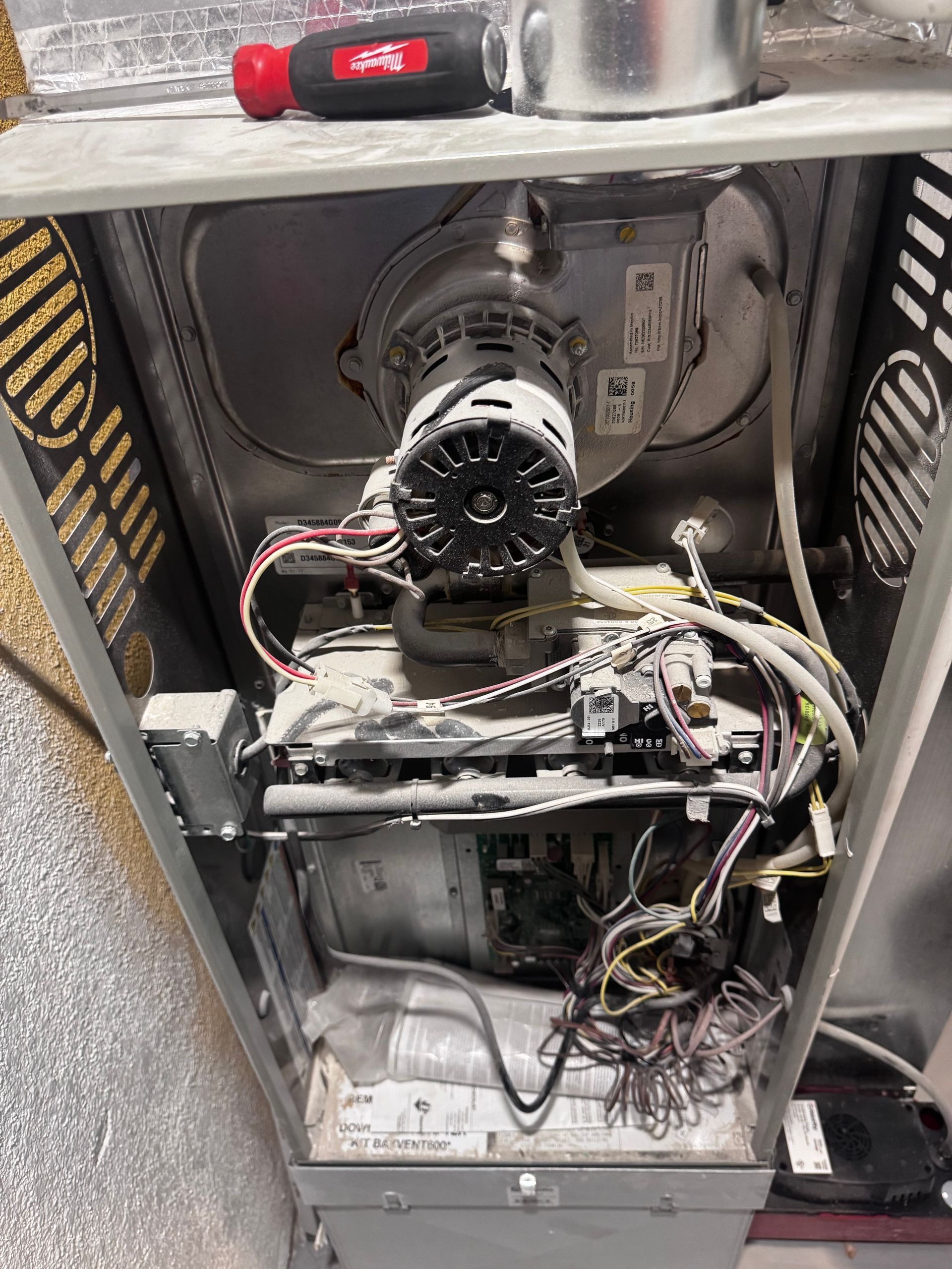 A large gray air conditioner is sitting on a table.