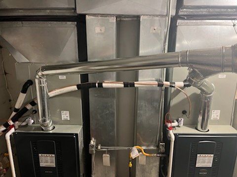 A couple of air conditioners are sitting next to each other in a room.