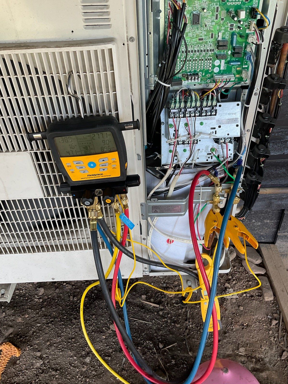 A hose is connected to a machine that is being repaired.